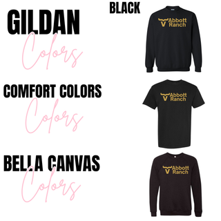 Abbott Ranch Logo Top in Gold shown in black across three brands from Seven Feathers Boutique, Gildan crewneck sweatshirt, Comfort Colors tee, and Bella Canvas crewneck sweatshirt all with gold logo