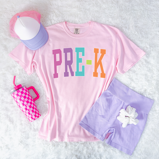 Pink Pre-K rainbow letter graphic shirt styled with lavender shorts and accessories
