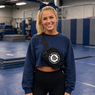 Model wearing a black Topeka Wildcats Wrestling Club Circle Logo belt bag crossbody style