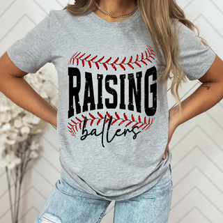 Raising Ballers baseball graphic top on grey shirt with red stitching design worn with jeans