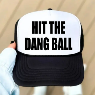 Hit the Dang Ball baseball foam trucker hat in black and white with bold block lettering across the front panel.