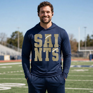 Male model wearing a true navy Topeka Saints Stacked Football PosiCharge Competitor Hoodie with distressed gold lettering