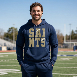 Male model wearing a deep navy Topeka Saints Stacked Football Performance Fleece Hoodie with distressed gold lettering