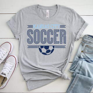 grey Bella Canvas shirt with Kansas City Soccer stripe graphic and white soccer ball design