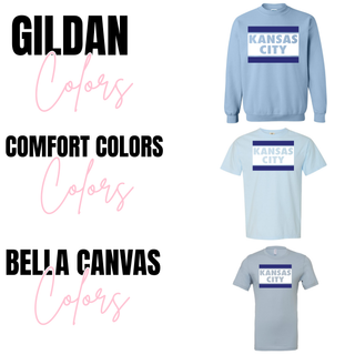 Light blue Kansas City block stripe apparel shown in sweatshirt, Comfort Colors shirt, and Bella Canvas shirt styles with bold navy stripe design