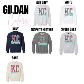 Gildan KC Soccer crewneck sweatshirt color options including Ash Grey, White, Navy, Graphite Heather, Sport Grey, and Sand featuring red KC letters with soccer ball pattern and teal Soccer script across the front.