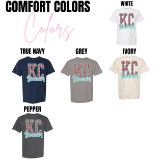Comfort Colors KC Soccer t shirt color options including White, True Navy, Grey, Ivory, and Pepper featuring red KC letters with soccer ball pattern and teal Soccer script overlay.