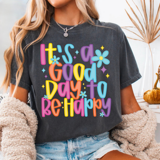 Dark charcoal graphic top featuring colorful It’s a Good Day to Be Happy lettering with retro flowers and bright multicolor text.