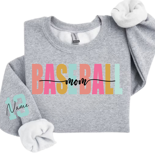 Personalized baseball mom name and number graphic Gildan sweatshirt in sport grey featuring varsity style baseball mom lettering with custom player name and number on the sleeve.
