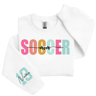Soccer Mom personalized sweatshirt with blue print lettering and custom sleeve number, shown on a white crewneck.