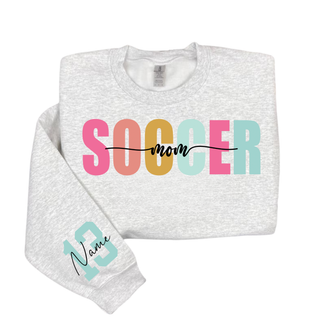 Soccer Mom personalized sweatshirt with blue print lettering and custom sleeve number, shown on a ash grey crewneck.