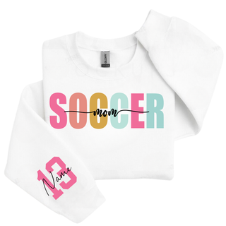 white crewneck sweatshirt with pastel Soccer Mom graphic and custom pink sleeve number personalization.