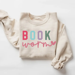 Cream sweatshirt with multicolor Book lettering and pink script worm graphic for book lovers