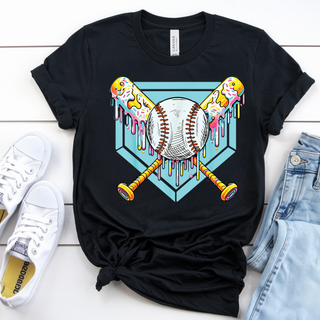 A black Bella Canvas top featuring a colorful ice cream baseball drip graphic with a detailed baseball centered over crossed bats and a teal geometric background, styled in a flat lay with white sneakers and denim.