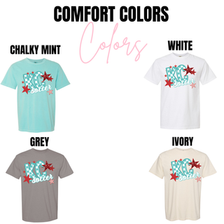 Comfort Colors tops in chalky mint, white, grey, and ivory featuring the KC soccer checkerboard graphic with teal lettering and red star accents displayed as brand color options.