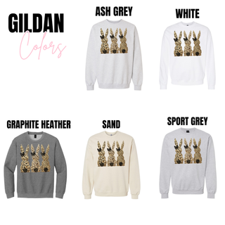 Leopard print Easter bunny graphic sweatshirt on Gildan crewneck in Ash Grey, White, Graphite Heather, Sand, and Sport Grey with three bunny silhouettes and black bow detail.
