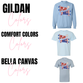 Play Ball pennant banner graphic shown on Gildan crewneck sweatshirt, Comfort Colors top, and Bella Canvas top in light blue featuring red and blue gingham pennant flags with stitched trim, bold Play Ball lettering, star accents, and a baseball graphic.