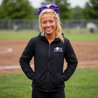 Woman wearing Bomb Squad Lavender Softball Logo Waterproof Insulated Jacket in Black on a softball field