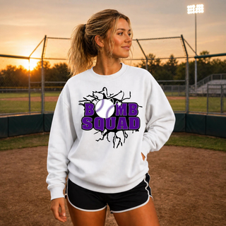 Woman wearing Bomb Squad Purple Softball Logo Top crewneck in White on a softball field
