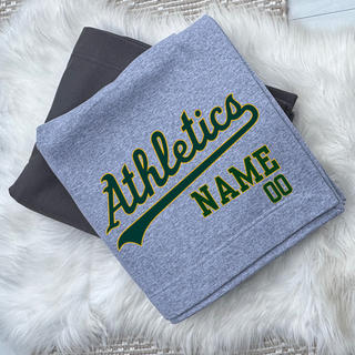 Topeka Athletics Baseball custom stadium blanket featuring Athletics script logo with personalized name and number shown on folded grey and black fleece blankets.