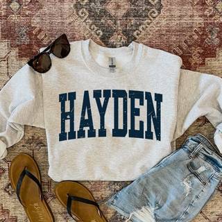 Hayden distressed collegiate spirit wear top in ash grey with navy lettering styled with denim shorts and sandals
