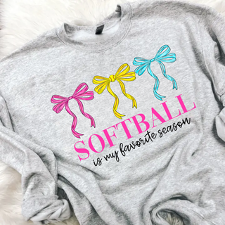 softball is my favorite season graphic sweatshirt with pink yellow and blue bows on grey top