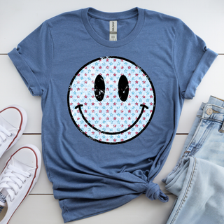 patriotic smiley face shirt with red white and blue star pattern on blue graphic top