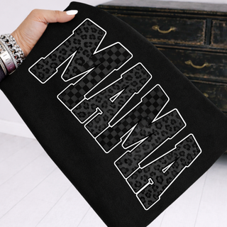 Black shirt featuring bold MAMA lettering with mixed leopard and checker print pattern inside the letters