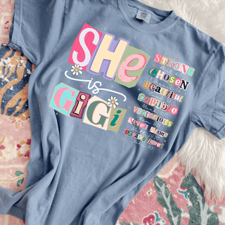 she is gigi christian graphic top with colorful scripture typography design on blue comfort colors shirt