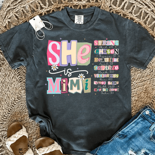 she is mimi christian graphic top with colorful scripture typography on dark comfort colors shirt styled with jeans and sandals