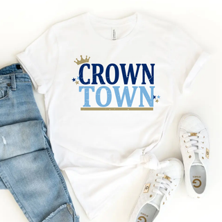 crown town graphic top with blue lettering, gold crown, and star accents on white shirt