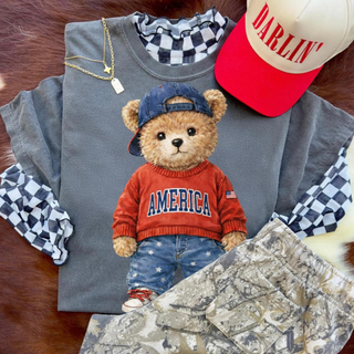 america teddy bear graphic top with patriotic bear wearing red sweater and denim shorts styled with layered outfit and accessories