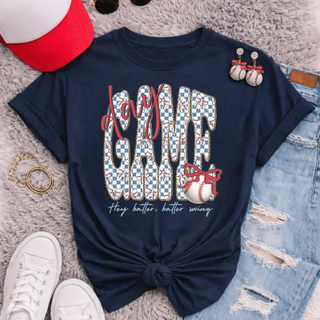 Baseball game day graphic top navy shirt with hey batter batter swing design styled with hat, earrings, and denim shorts