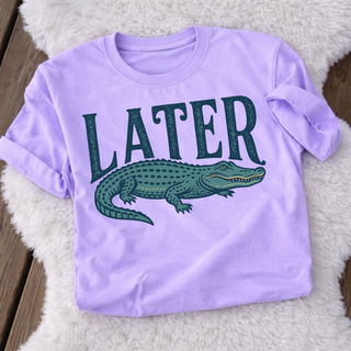 later gator graphic tee with alligator illustration and bold lettering on lavender shirt