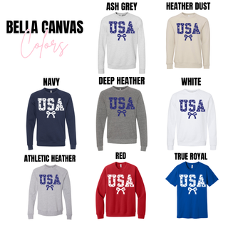 bella canvas vintage usa stars graphic sweatshirt and tee color options showing navy, deep heather, athletic heather, ash grey, heather dust, white, red, and true royal styles with usa star filled lettering and bow graphic displayed on lightweight crewneck sweatshirts and tees