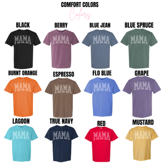 Comfort Colors mama graphic top shown in extended color options including black, berry, blue jean, blue spruce, burnt orange, espresso, flo blue, grape, lagoon, true navy, red, and mustard, all with bold white varsity “MAMA” text