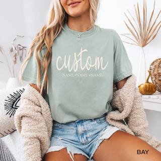 custom name graphic tee in bay green with personalized text and optional names below styled with cozy cardigan and fall decor