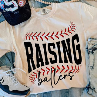 raising ballers baseball graphic top styled with denim shorts white athletic sneakers and navy baseball cap