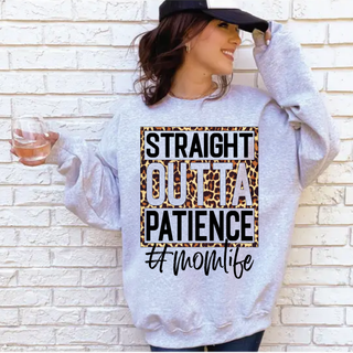 Straight Outta Patience Leopard Momlife Top in Sport Grey Gildan crewneck sweatshirt with leopard print graphic and hashtag momlife script lettering, worn by brunette model holding wine glass against brick wall