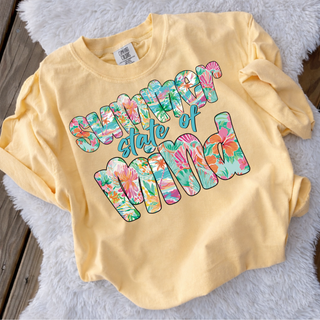 Summer State of Mind Floral Top in Butter Comfort Colors long sleeve tee with colorful tropical floral patterned lettering, flat lay on white fur background