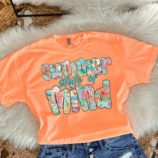 Summer State of Mind Floral Top in Neon Cantaloupe Comfort Colors tee with colorful tropical floral patterned lettering, flat lay styled with denim shorts
