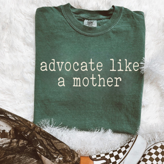 Advocate Like a Mother Comfort Colors tee in green with cream statement lettering