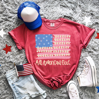 Crimson Comfort Colors All American Girl tee styled flat lay with flag hat and sneakers