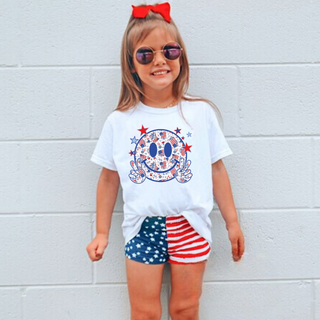 White kids tee with All American smiley face graphic featuring red white and blue patriotic print filled smiley face with peace sign hands and stars
