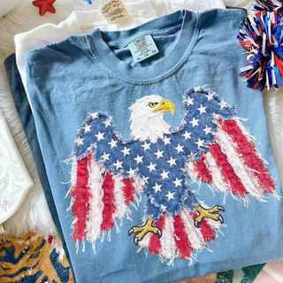 Blue jean tee with a large faux patch american flag bald eagle graphic with wings spread wide across the front
