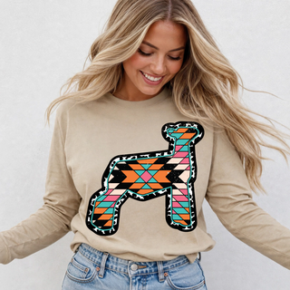 Woman wearing tan long sleeve top with colorful Aztec print show lamb graphic