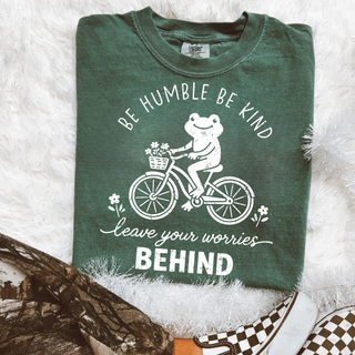 Blue spruce tee folded flat with BE HUMBLE BE KIND leave your worries BEHIND frog on bicycle and flower graphic
