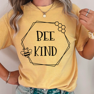 Woman wearing mustard tee with BEE KIND hexagon honeycomb frame and cute bee illustration front view
