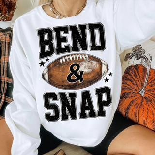 Woman wearing white crewneck with bend and snap football graphic design
