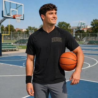 Birddogs Basketball Camo Half-Zip Short Sleeve Jacket in Black, worn on a basketball court, featuring camo BIRDDOGS lettering on the left chest